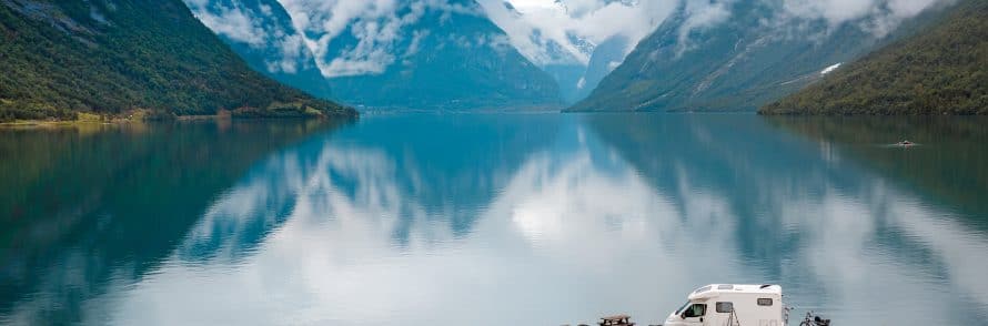 camper van with mountain lake backdrop